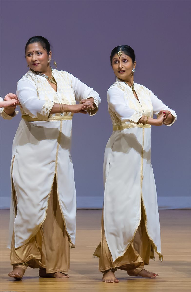 Sapna Adhikari and Aarti Gupta performing Kathak in white and gold attire on stage