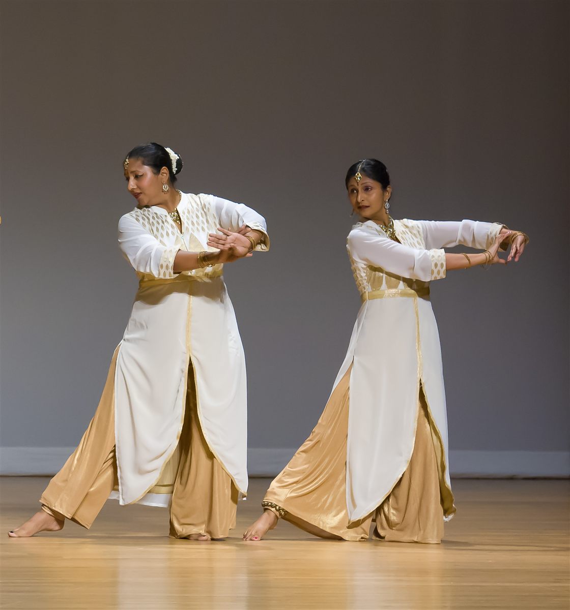 Sapna Adhikari and Aarti Gupta in expressive Kathak poses in white and gold classical attire